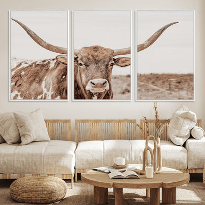 A longhorn cow in soft beige desert tones, standing calmly in open land, perfect for neutral western or rustic farmhouse interiors.