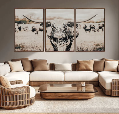 Canvas of a speckled Texas longhorn standing boldly in a field with a herd behind, perfect for rustic western or farmhouse wall decor.