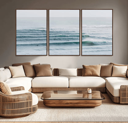 High-angle view of surfers lining up across layered ocean waves, ideal for minimal coastal or surf-inspired room decor.