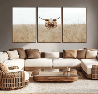 Texas Longhorn bull standing alone in dry grass with neutral tones, ideal for rustic western or cowboy-themed wall decor.