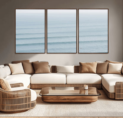 Framed canvas of repeating ocean waves with a distant solo surfer, ideal for minimalist ocean or calm coastal wall decor.