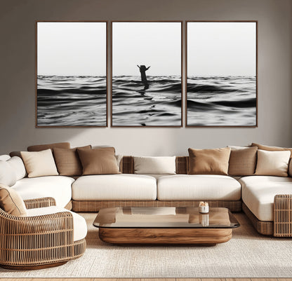 Black and white ocean with a hand making a surfer sign among dark waves, creating a dramatic and minimalist seascape with bold contrast.
