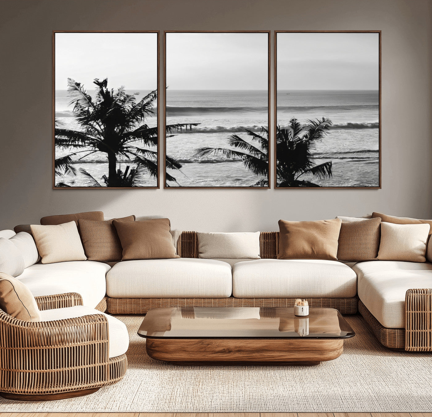 Black and white view of ocean waves crashing on a tropical coastline, framed by silhouetted palm trees under a vast, open sky.