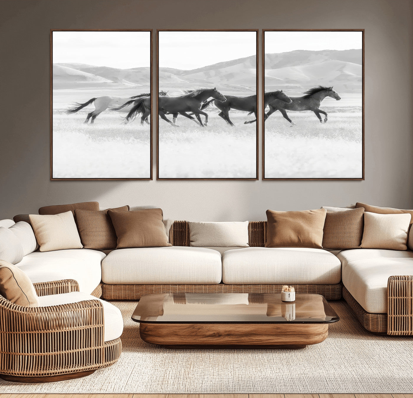 A black and white image of wild horses running freely across an open grassland, capturing the power and beauty of untamed nature in a rustic western setting.