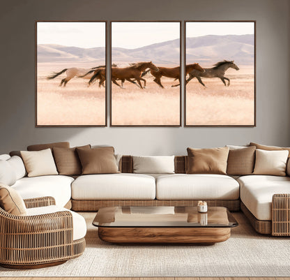A herd of wild horses galloping through a sunlit desert plain with mountains in the background, perfect for rustic or western-themed wall decor.