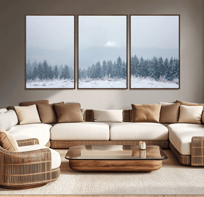 Snow-covered forest under misty sky, soft light breaking through clouds, ideal for minimalist or Nordic-inspired home decor.