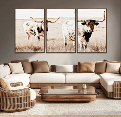 Two Texas longhorn cows standing in a sepia-toned pasture, evoking rustic charm perfect for farmhouse or western country interiors. (