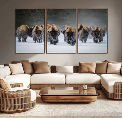 A herd of American bisons walking through deep snow in a forest, evoking a powerful rustic wilderness mood for western-style interiors.
