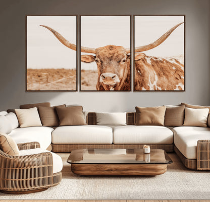 A longhorn bull standing proudly in a sunlit desert field with warm neutral tones, ideal for rustic western or farmhouse interiors.