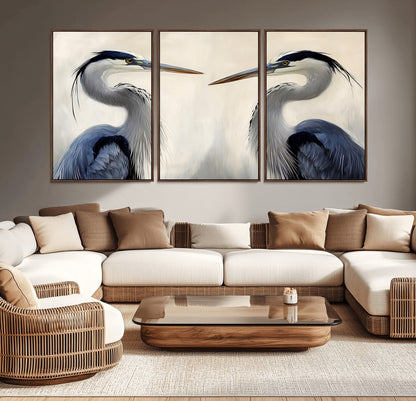 Two blue herons facing each other on a soft neutral background, ideal for coastal, tranquil, or nature-inspired minimalist interiors.