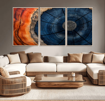 A captivating close-up of a tree trunk, showcasing its concentric rings in rich shades of blue, orange, and brown, highlighting the organic patterns of natural wood.