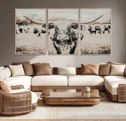Canvas of a speckled Texas longhorn standing boldly in a field with a herd behind, perfect for rustic western or farmhouse wall decor.