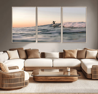 Framed canvas of a female surfer balancing on a wave at sunset, perfect for serene surf or ocean-inspired coastal decor.