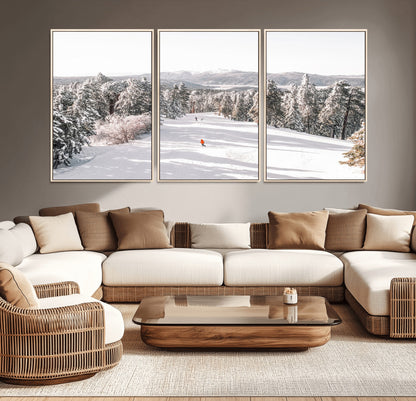 Bright ski trail lined with snow-covered pines and a skier in orange, perfect for alpine adventure or winter sports-inspired decor.