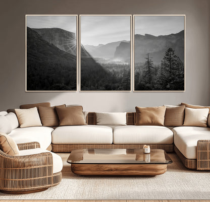 Black and white landscape of Yosemite with sun rays peeking over El Capitan, ideal for moody nature or modern rustic decor.