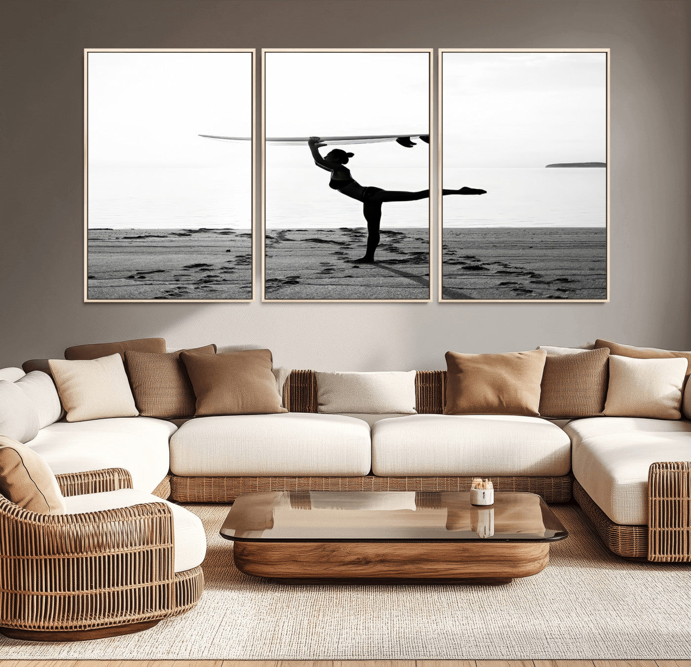 A woman balances a surfboard on her head while striking a yoga pose on the beach, silhouetted against a calm ocean horizon.
