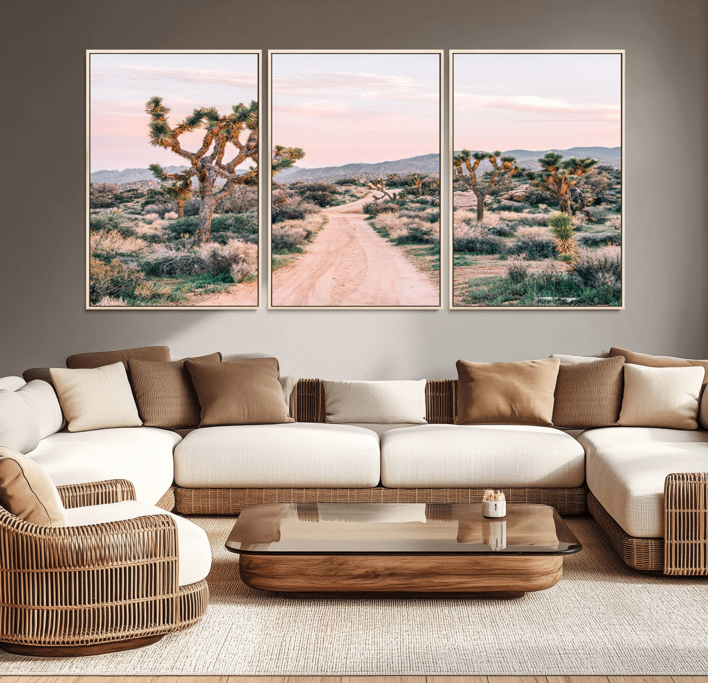 A dusty road winding through Joshua Tree National Park, framed by iconic twisted trees and warm desert tones under a soft pastel sky.