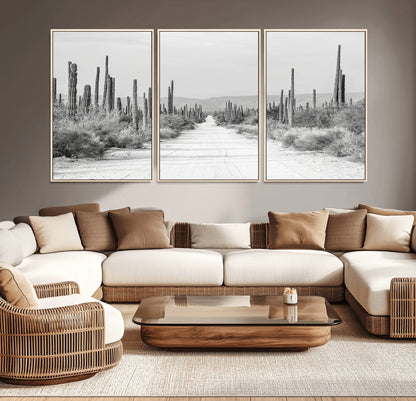A black and white desert road stretching through a cactus-filled landscape, creating a rugged and timeless southwestern aesthetic with a sense of adventure.