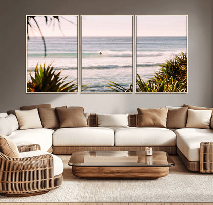 Canvas of a lone surfer riding a pastel wave at sunrise, perfect for tropical or coastal-themed spaces with a relaxed, airy vibe.