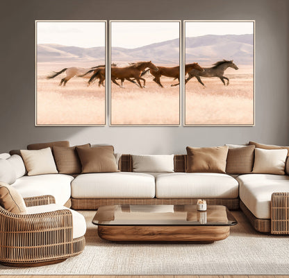 A herd of wild horses galloping through a sunlit desert plain with mountains in the background, perfect for rustic or western-themed wall decor.