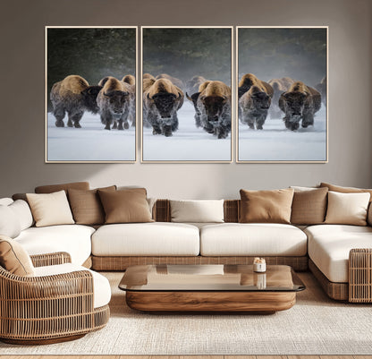 A herd of American bisons walking through deep snow in a forest, evoking a powerful rustic wilderness mood for western-style interiors.