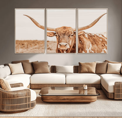 A longhorn bull standing proudly in a sunlit desert field with warm neutral tones, ideal for rustic western or farmhouse interiors.