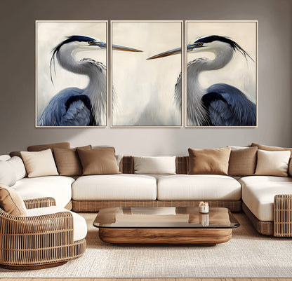 Two blue herons facing each other on a soft neutral background, ideal for coastal, tranquil, or nature-inspired minimalist interiors.