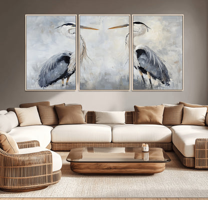 Two herons facing each other on a soft-toned background with blue-grey feathers, perfect for tranquil, coastal or nature-themed interiors.