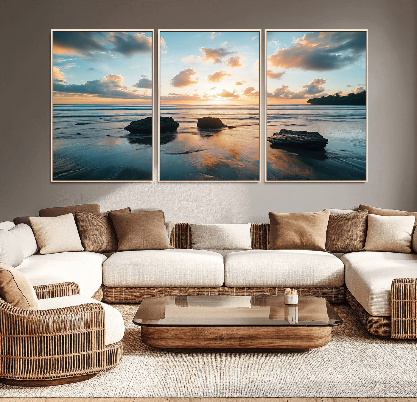 A serene beach at sunset with vibrant clouds, calm water, and rocks in the foreground reflecting the warm colors of the setting sun.