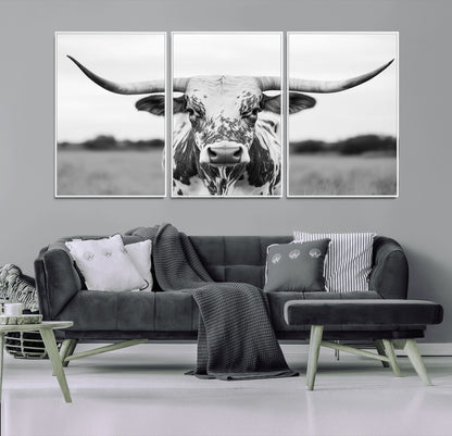 Capture the strength and elegance of nature with this striking black and white portrait of a longhorn cow. Its powerful presence makes a bold statement in any room.