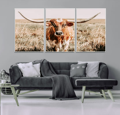 Framed longhorn cow canvas wall art with rustic prairie background, western animal print perfect for farmhouse or ranch style decor