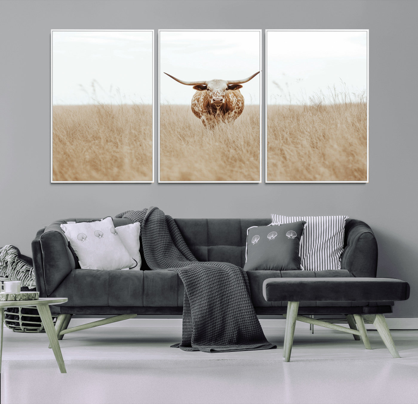 Texas Longhorn bull standing alone in dry grass with neutral tones, ideal for rustic western or cowboy-themed wall decor.