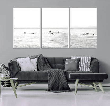 Monochrome photo of surfers riding and waiting on ocean waves, ideal for surf-themed or coastal energy wall decor.