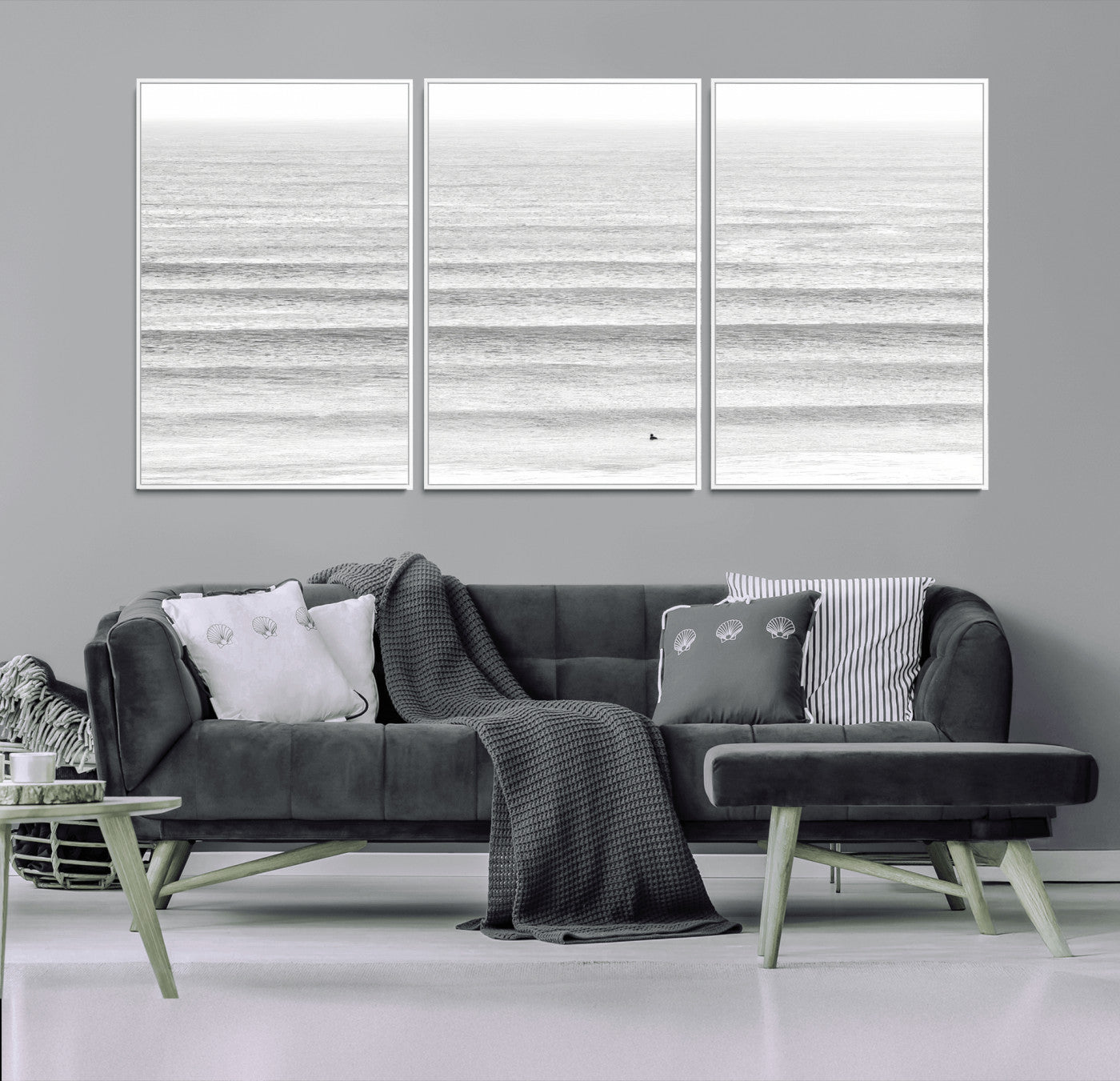 Monochrome photo of a lone surfer in calm layered waves, perfect for minimalist coastal or moody ocean-inspired wall decoration.