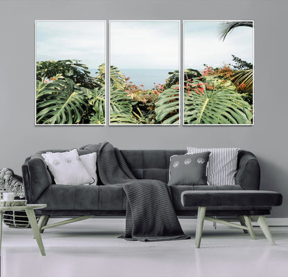 Monstera leaves and tropical flowers framing a calm ocean view, ideal for tropical coastal or exotic jungle-style interior wall decor.