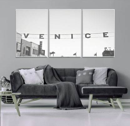 Black and white photo of Venice Beach sign and palm-lined street, perfect for urban coastal or minimalist LA-inspired wall decoration.