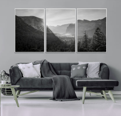 Black and white landscape of Yosemite with sun rays peeking over El Capitan, ideal for moody nature or modern rustic decor.