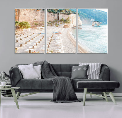 Wall art of a calm Mediterranean beach with rows of sun loungers and umbrellas in soft pastel tones, perfect for light coastal or vacation-themed decor.