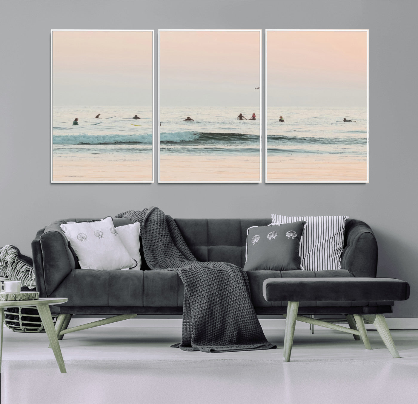 Dreamy photo of surfers waiting on soft pastel waves under a pink sunset sky, ideal for soft coastal minimalist or serene ocean-themed home decor.