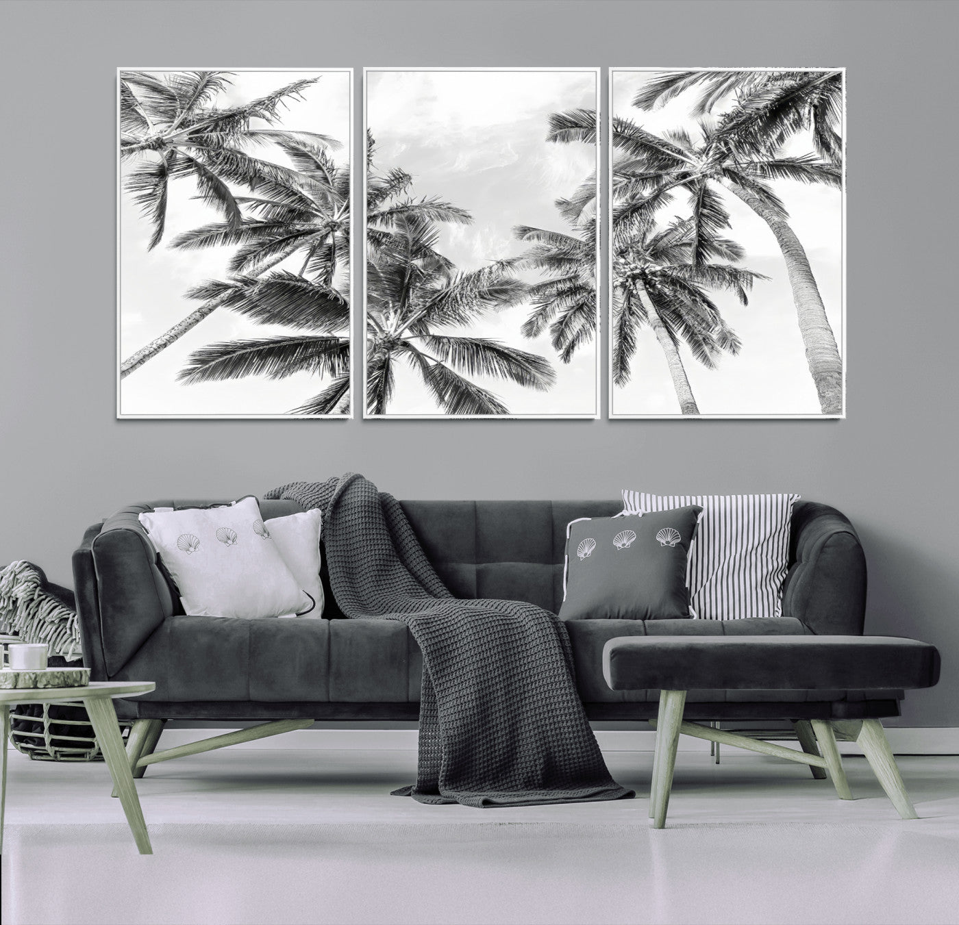 Black and white tropical palm trees viewed from below, swaying gently against a bright sky, creating a serene and elegant coastal atmosphere.
