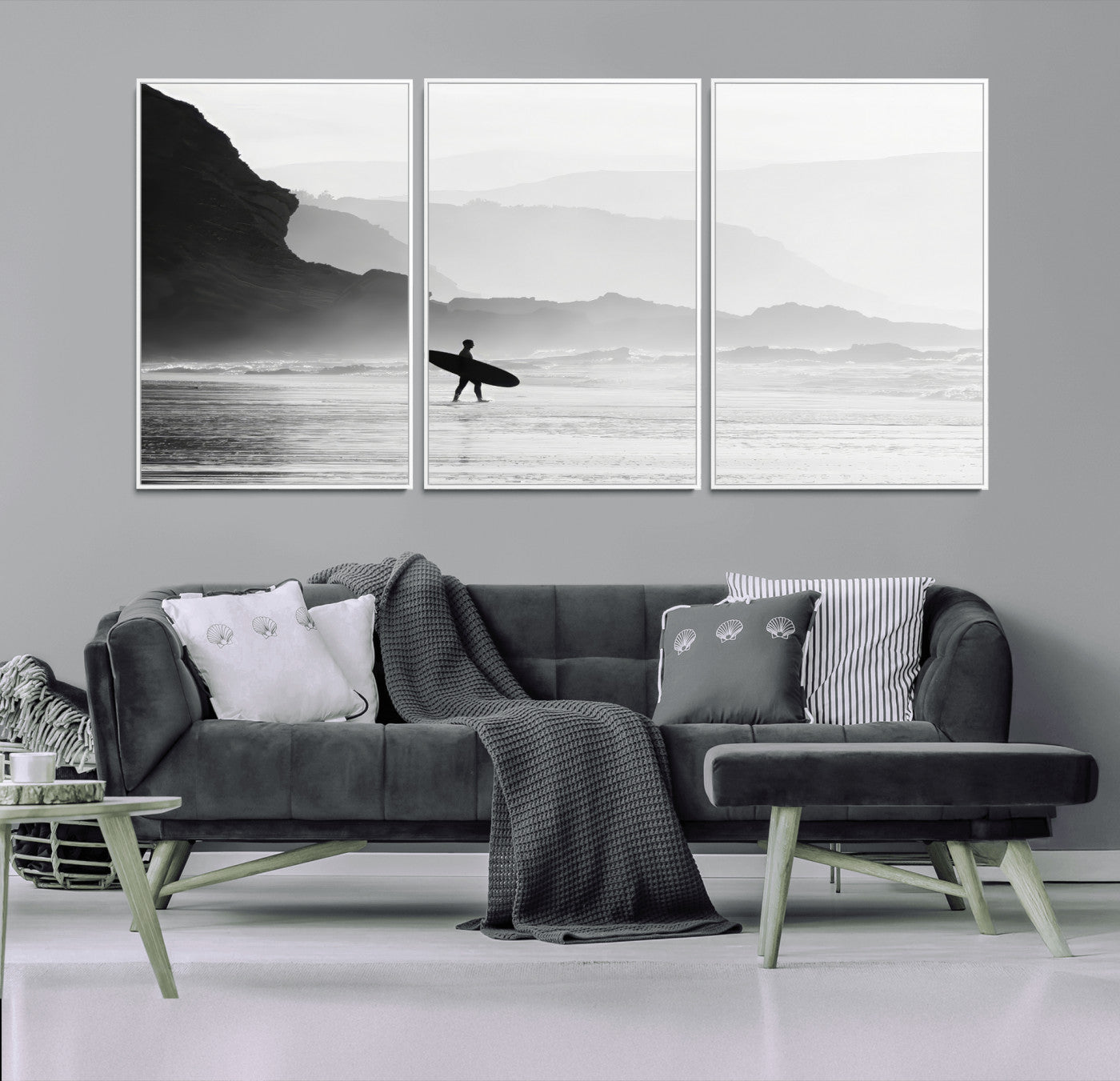 A lone surfer walking along a misty beach with cliffs in the background, carrying their board, capturing a serene and minimal ocean moment.