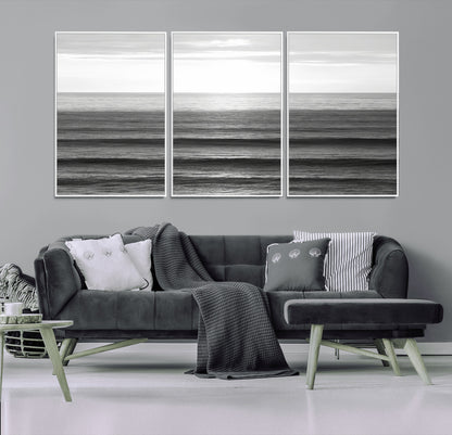 Minimalist black and white ocean view with layered waves reflecting sunlight, evoking a sense of calm and coastal serenity.