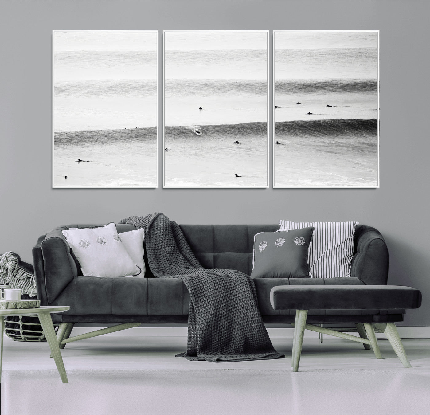 A monochrome photograph of swimmers gliding through gentle ocean waves, evoking a sense of calm and movement.