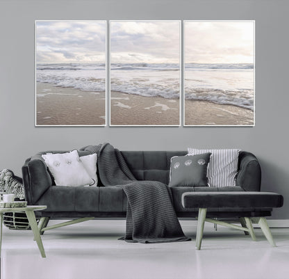 Peaceful ocean waves rolling onto the sandy shore under soft light, perfect for neutral or coastal minimalist decor themes.