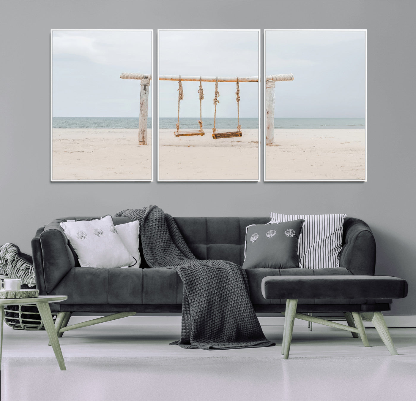 A rustic wooden beach swing stands on a serene sandy shore with an ocean horizon in the background, creating a tranquil and dreamy coastal escape.