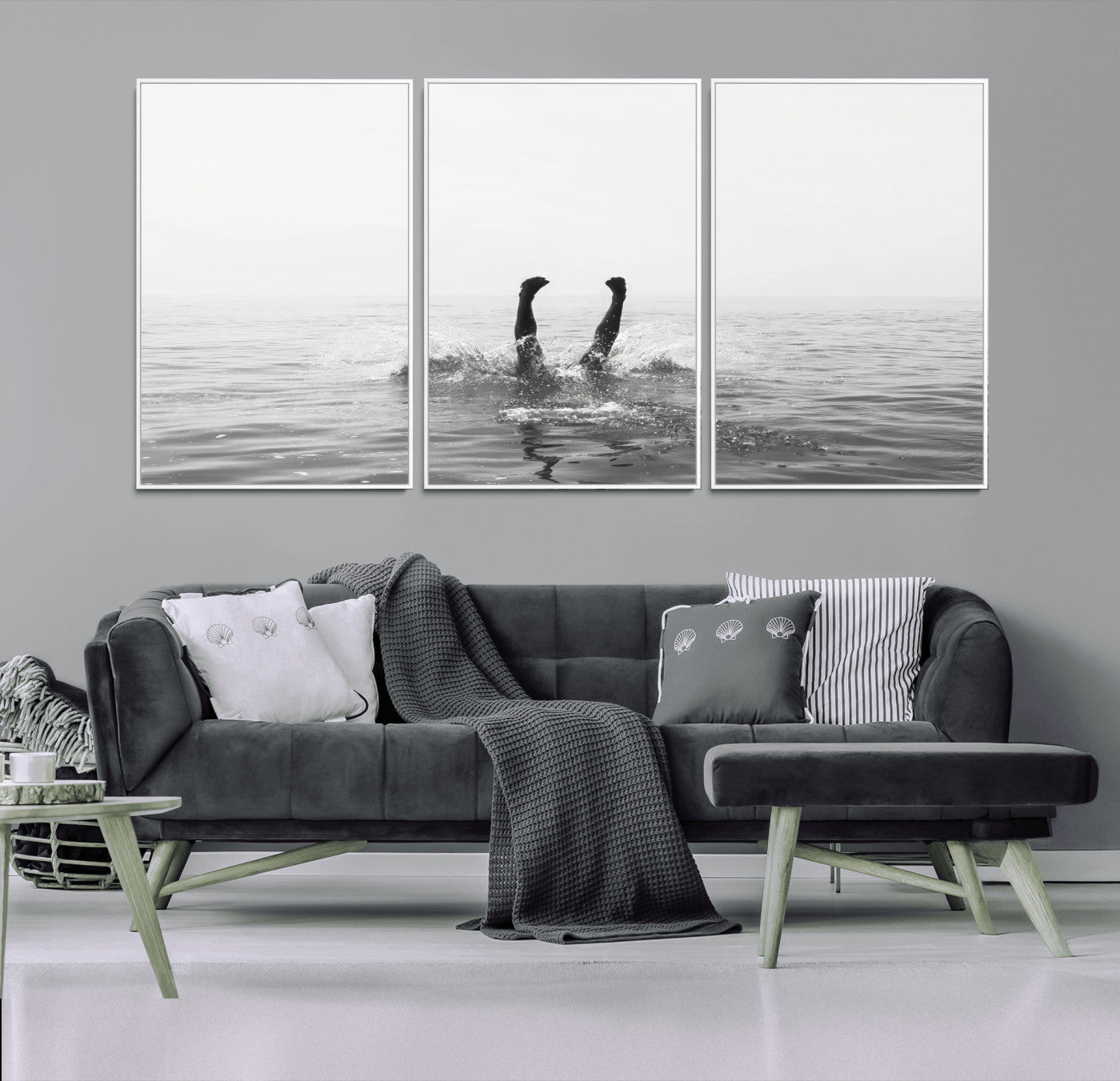 A black and white minimalist water scene capturing a playful splash as a swimmer dives upside down, creating a carefree and artistic aquatic aesthetic.