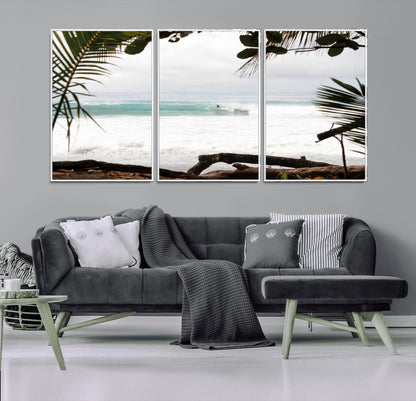 Tropical beach view with palm trees and surfer riding a wave, perfect for boho or coastal-inspired interior wall decor.