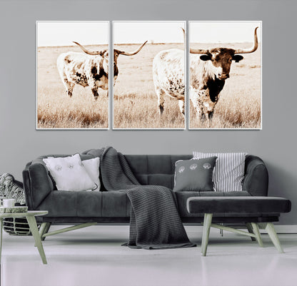 Two Texas longhorn cows standing in a sepia-toned pasture, evoking rustic charm perfect for farmhouse or western country interiors. (