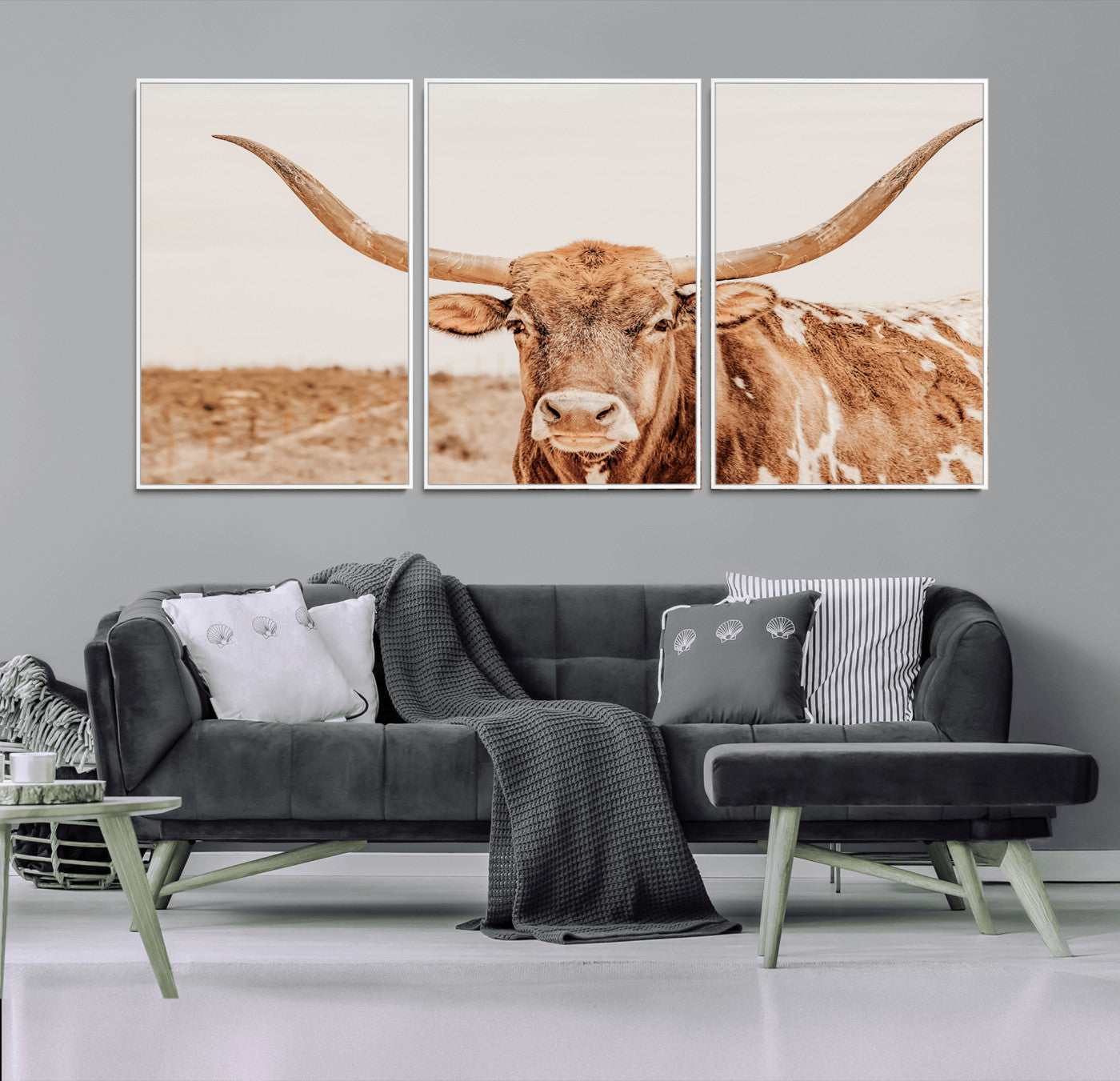 A longhorn bull standing proudly in a sunlit desert field with warm neutral tones, ideal for rustic western or farmhouse interiors.