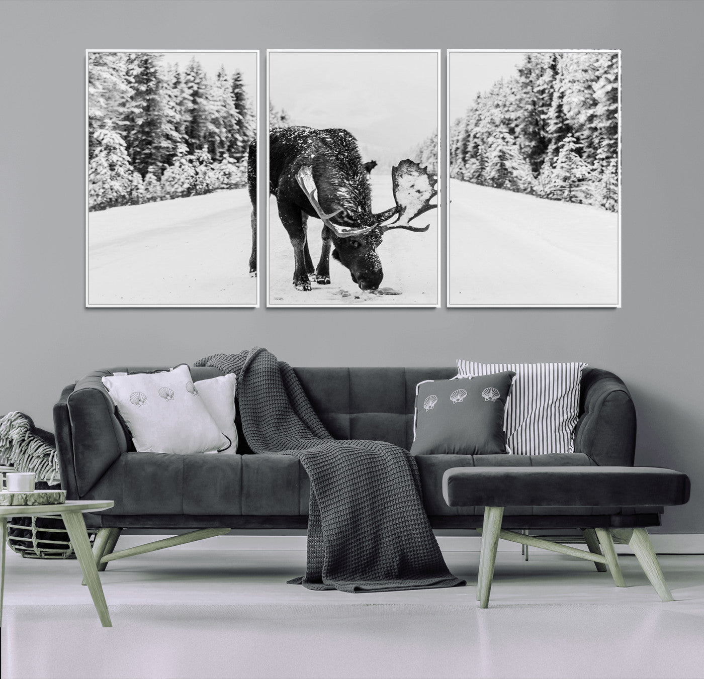 A majestic moose grazing in the snow-covered wilderness, surrounded by snow-covered trees, creating a peaceful winter scene.